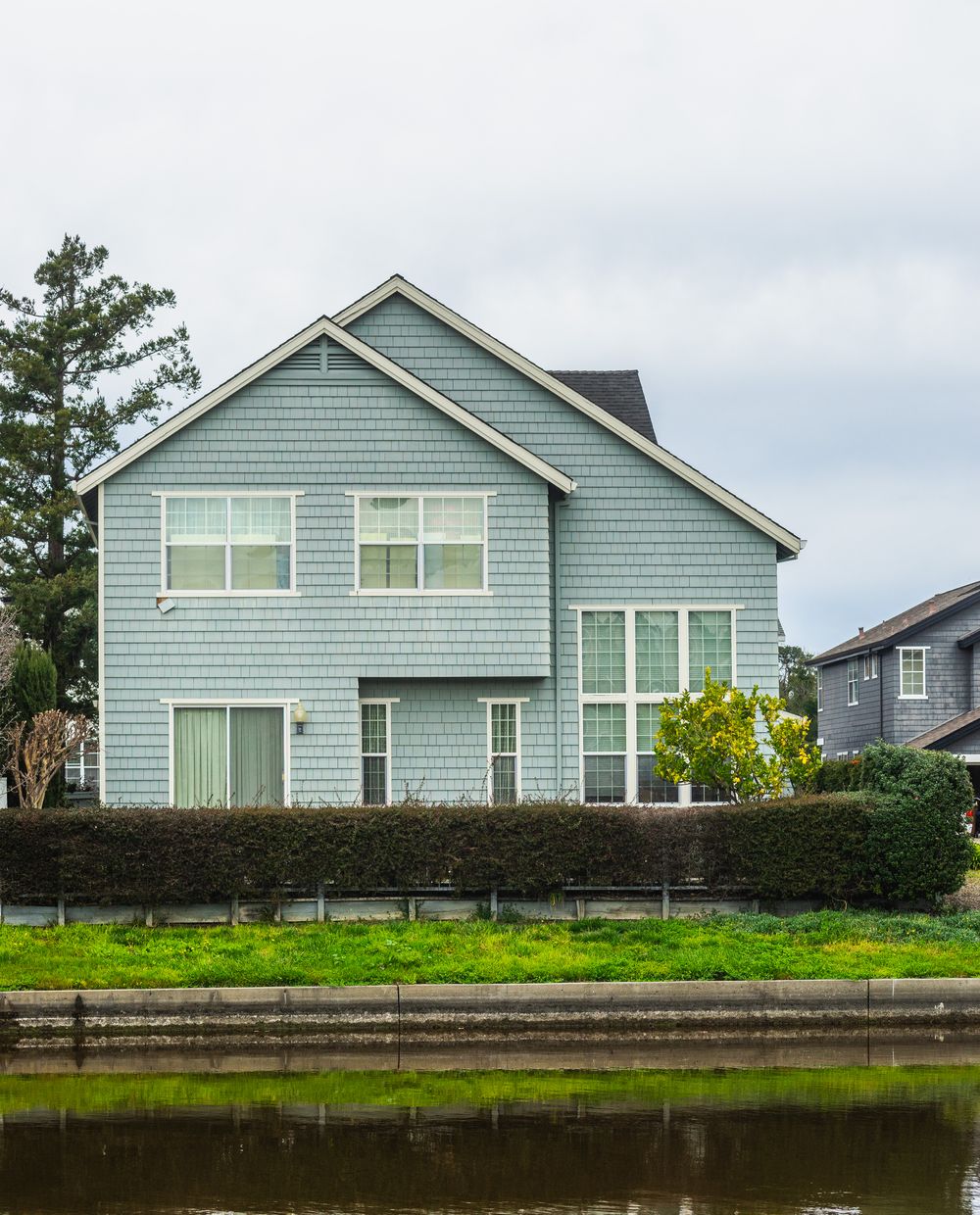 Sage green two-story house exterior