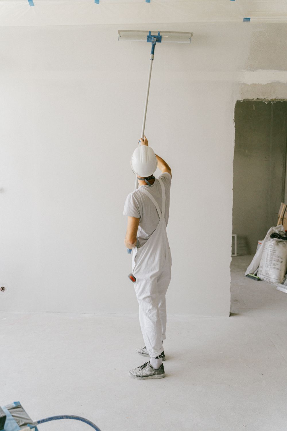 Painter rolling fresh paint on an interior wall
