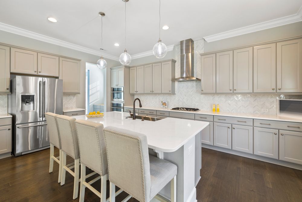 Freshly painted greige kitchen cabinets with an island